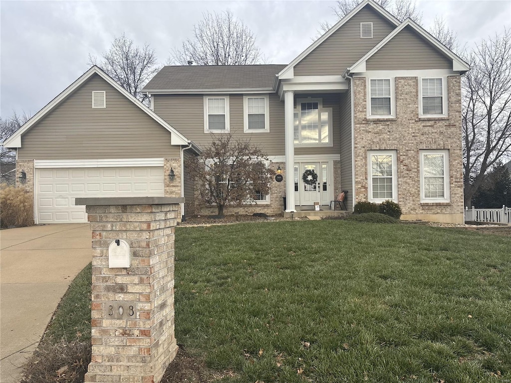 view of front of property with a front lawn and a garage