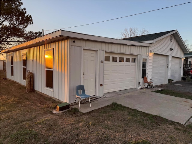 view of garage at dusk