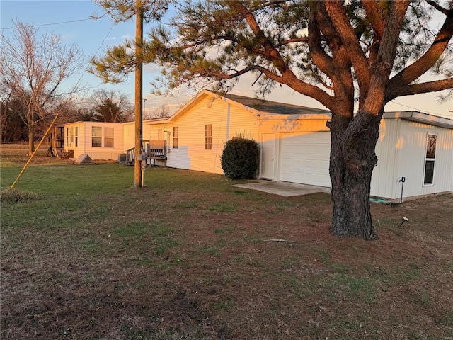 view of property exterior featuring a yard and a garage