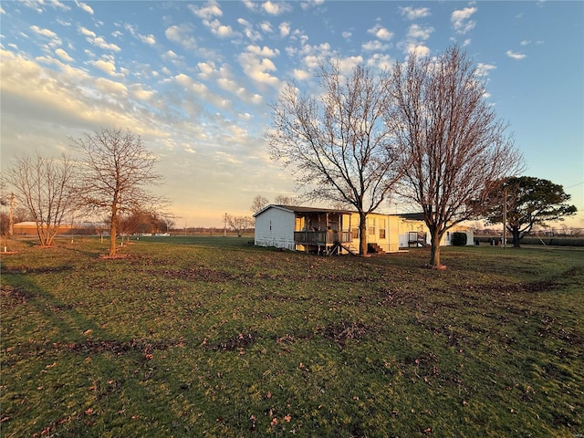 yard at dusk with a rural view