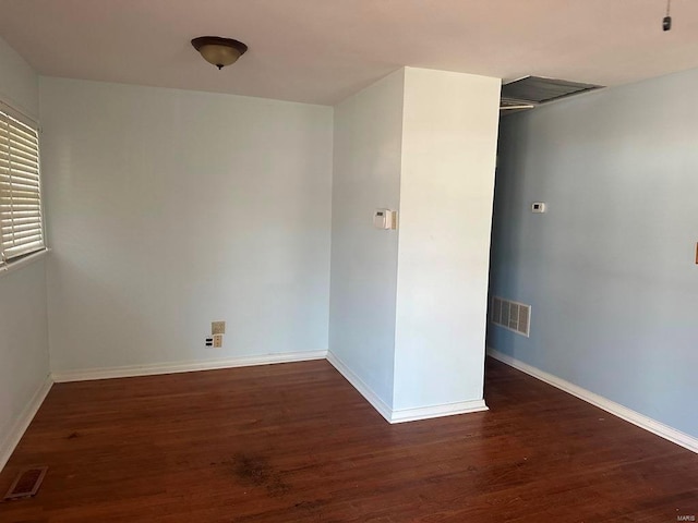 unfurnished room featuring dark wood-type flooring