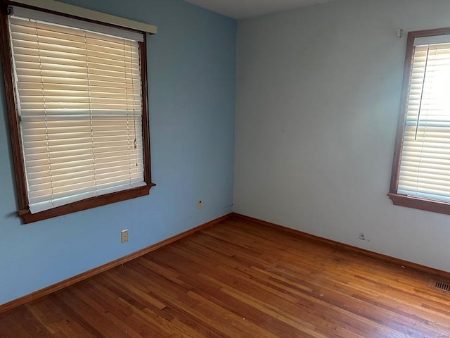 unfurnished room with hardwood / wood-style flooring