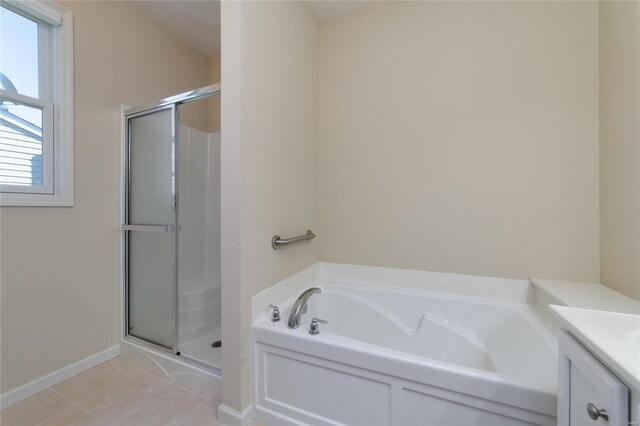 bathroom featuring vanity, tile patterned floors, and plus walk in shower