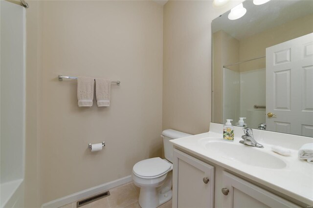 bathroom with vanity, walk in shower, tile patterned floors, and toilet