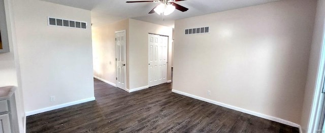 unfurnished room with ceiling fan and dark wood-type flooring