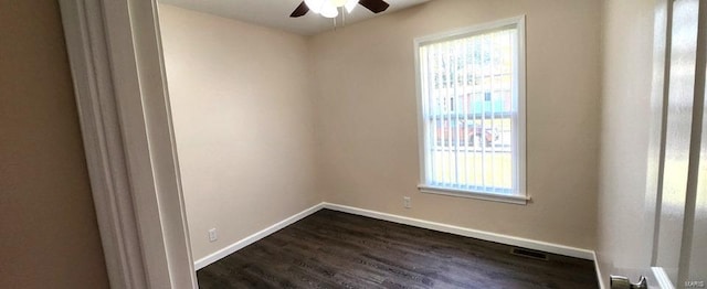 empty room with ceiling fan and dark wood-type flooring