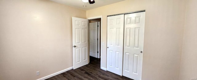 unfurnished bedroom featuring a closet, dark wood-type flooring, and ceiling fan