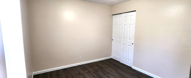 empty room featuring dark wood-type flooring