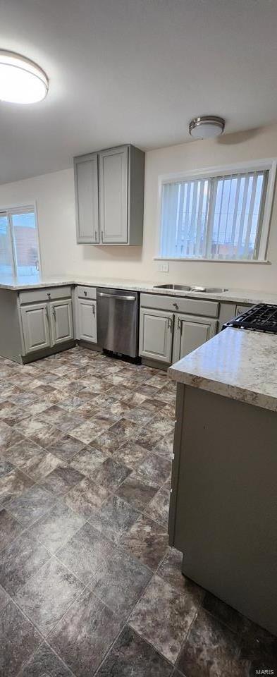 kitchen featuring gray cabinetry and dishwasher