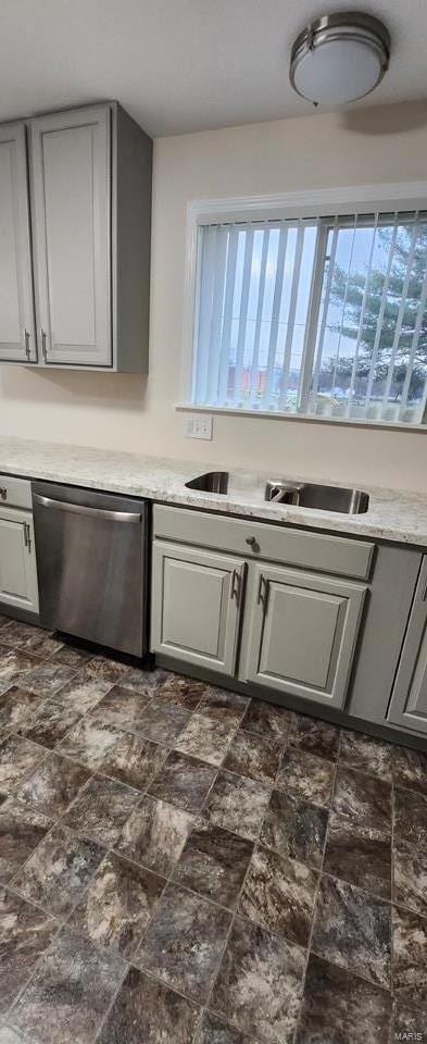 kitchen featuring dishwasher, gray cabinets, and sink