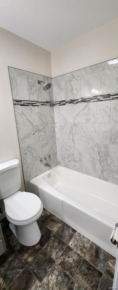 bathroom featuring washtub / shower combination and toilet