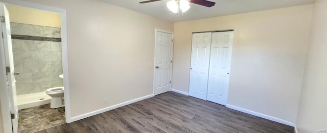 unfurnished bedroom with dark hardwood / wood-style flooring, ensuite bathroom, and ceiling fan