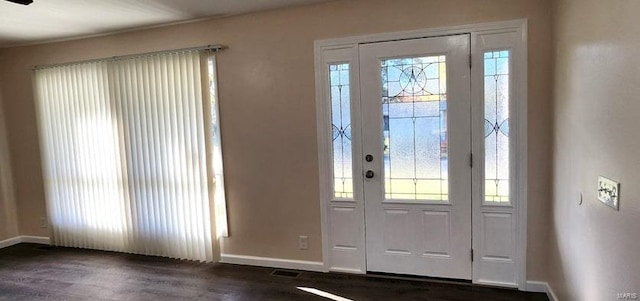 entryway with plenty of natural light and dark hardwood / wood-style floors