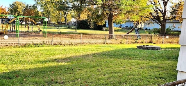 view of yard featuring a fire pit and a playground