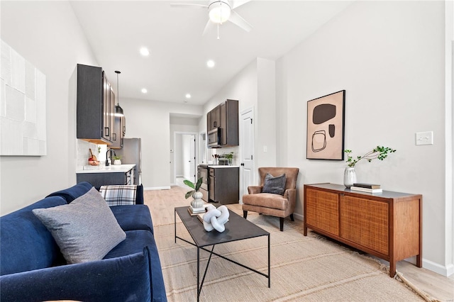 living room with light hardwood / wood-style floors and ceiling fan