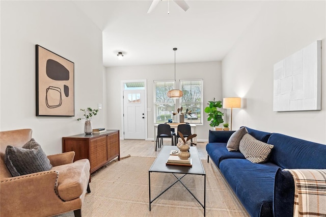 living room featuring ceiling fan and light hardwood / wood-style floors