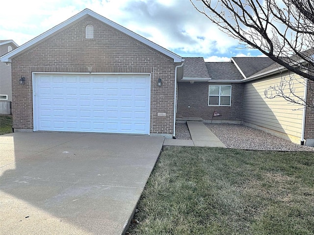 rear view of house with a garage and a yard