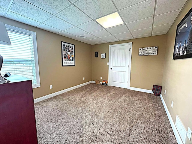 interior space with carpet flooring and a drop ceiling