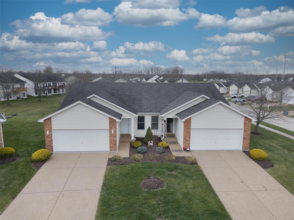 ranch-style home with a front lawn and a garage