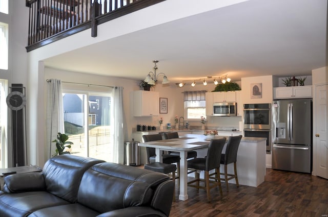 interior space with dark hardwood / wood-style floors, plenty of natural light, sink, and a chandelier