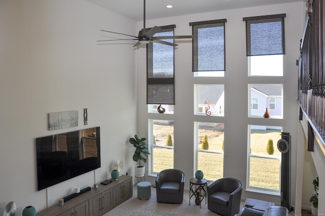 living room with carpet flooring and ceiling fan