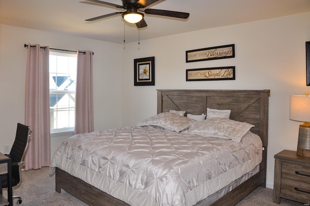 bedroom featuring ceiling fan, light carpet, and multiple windows