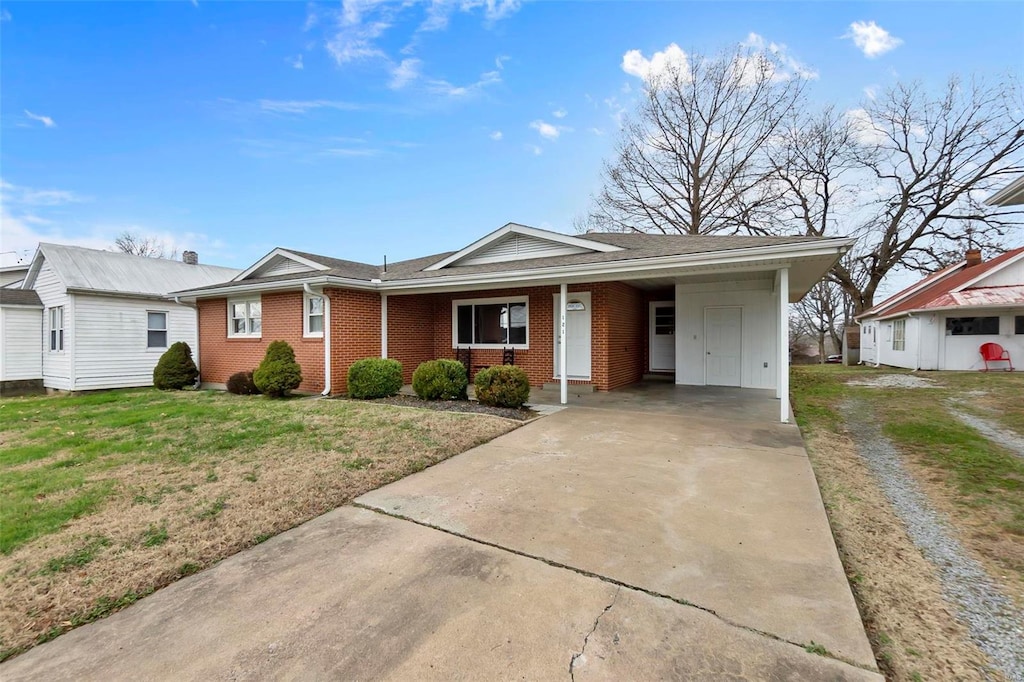 ranch-style house with a front lawn and a carport