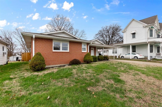 view of front facade featuring a carport and a front lawn