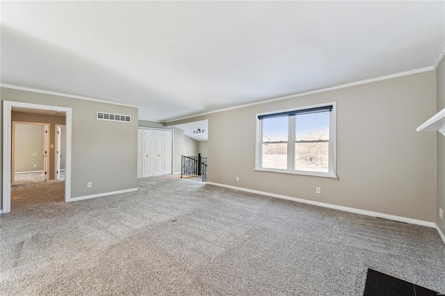 unfurnished living room featuring baseboards, visible vents, crown molding, and carpet flooring