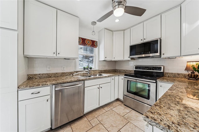 kitchen featuring decorative backsplash, white cabinetry, stainless steel appliances, and a sink