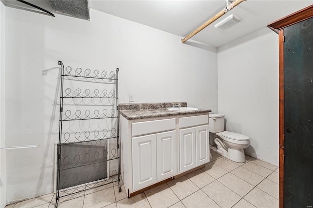 bathroom with visible vents, toilet, tile patterned flooring, vanity, and a walk in shower