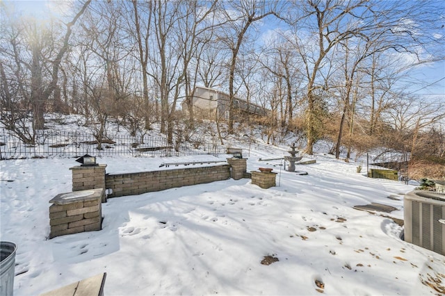 yard layered in snow with fence and central air condition unit