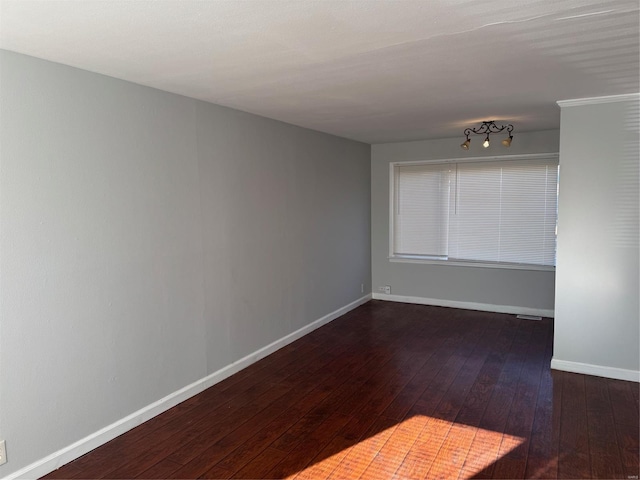 empty room with dark hardwood / wood-style floors