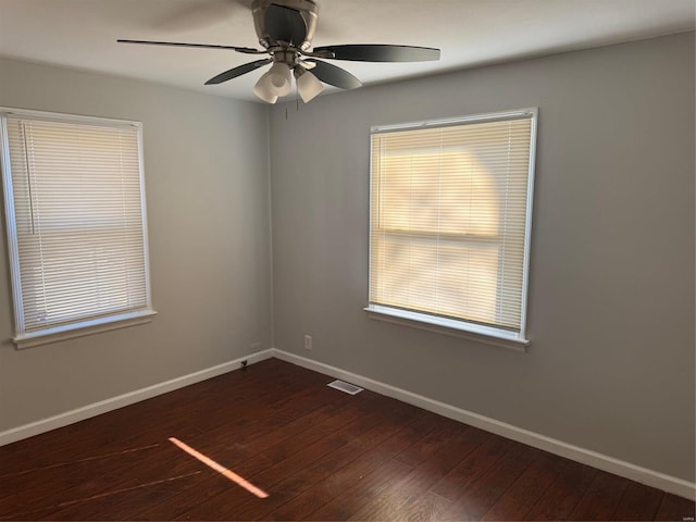 unfurnished room with dark hardwood / wood-style flooring and ceiling fan