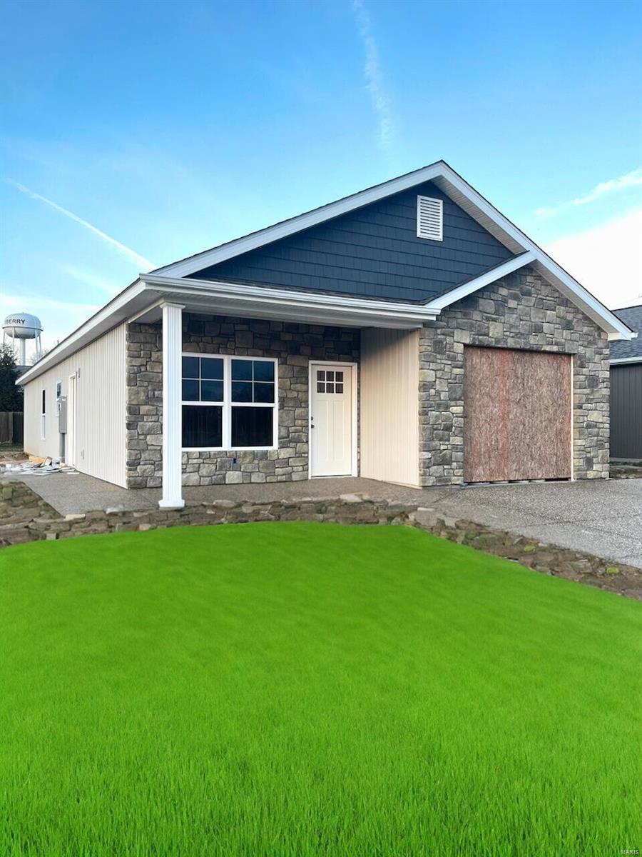 view of front of home with a front yard and a garage