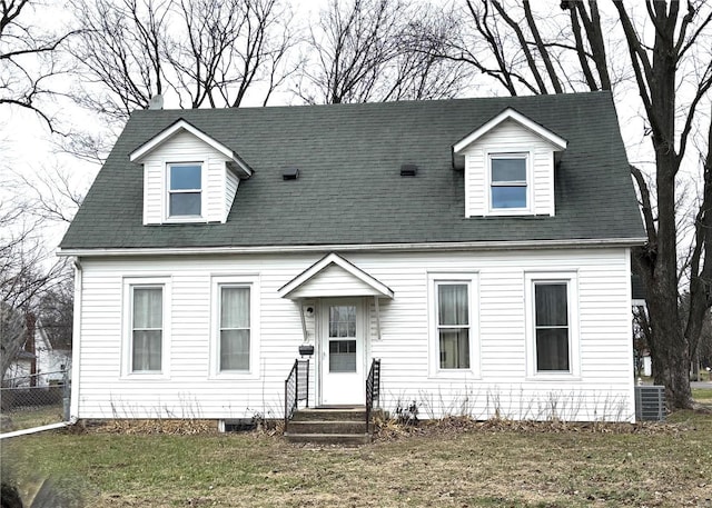 new england style home featuring central AC unit and a front yard