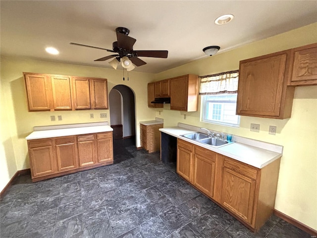 kitchen featuring ceiling fan and sink