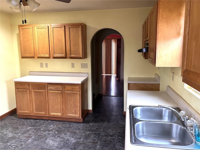 kitchen featuring ceiling fan and sink