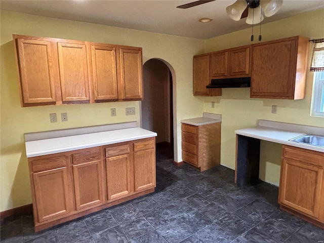 kitchen featuring ceiling fan and sink