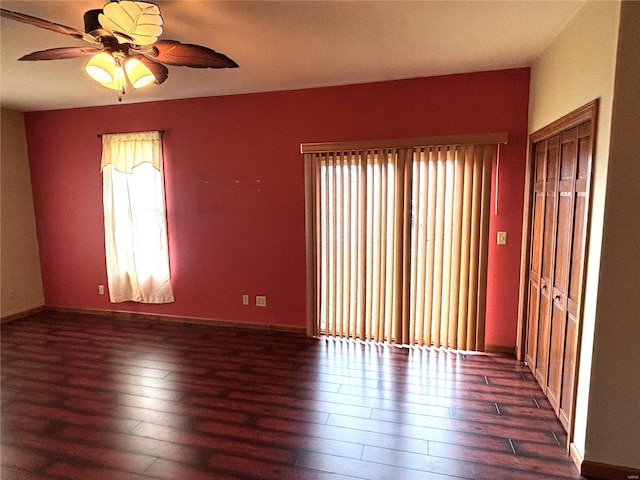 unfurnished room featuring ceiling fan and dark hardwood / wood-style floors