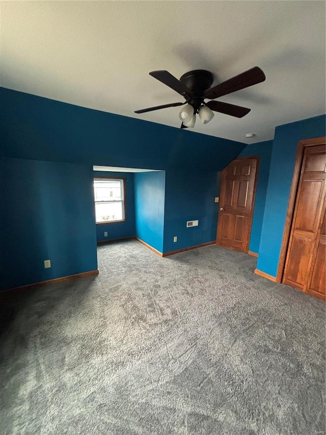 interior space with carpet and ceiling fan