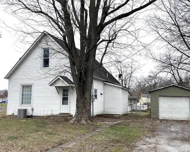 view of side of home with central AC, an outbuilding, and a garage