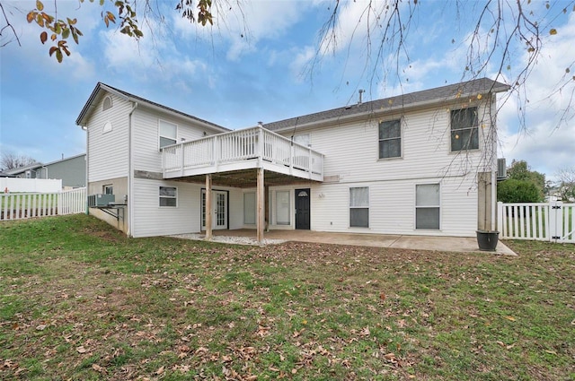 rear view of house featuring central AC, a patio, a deck, and a lawn