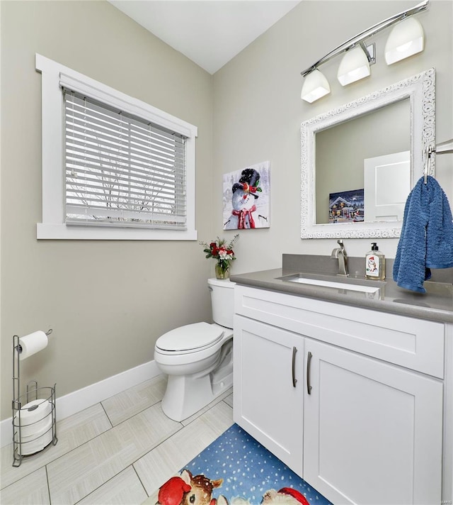 bathroom featuring toilet, vanity, and tile patterned flooring