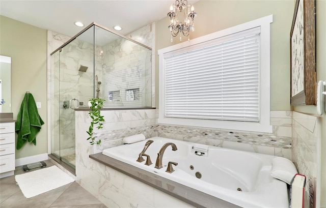 bathroom with a chandelier and shower with separate bathtub