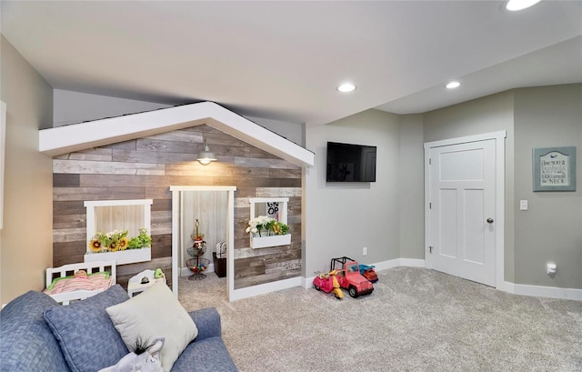 playroom featuring carpet and wood walls