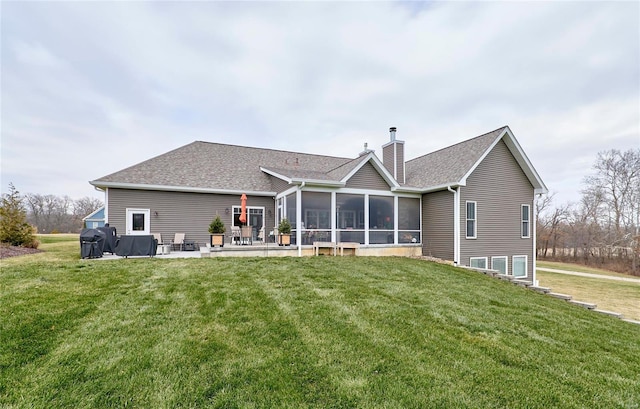 back of property featuring a sunroom, a yard, and a patio