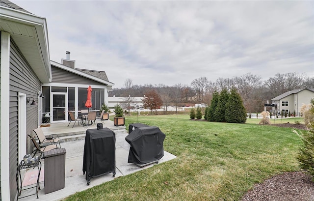 view of yard with a sunroom and a patio