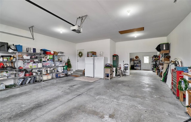 garage with white refrigerator and a garage door opener