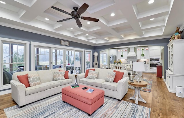 living room with light hardwood / wood-style flooring, coffered ceiling, ceiling fan, beam ceiling, and french doors